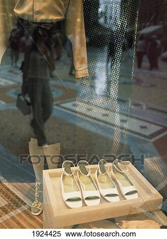 Stock Photography - Reflection Of Woman In Prada Shop. Fotosearch