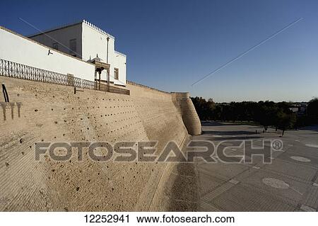 Stock Image - Registan square below the walls of the Ark Fortress, Old Town; Bukhara, Uzbekistan. Fotosearch