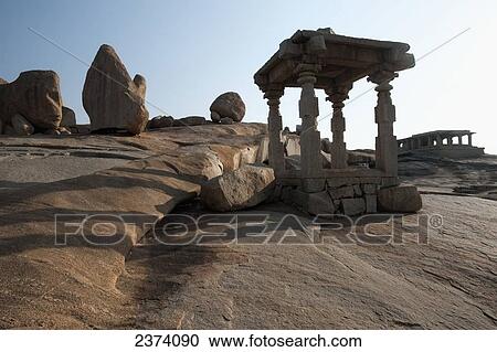 Stock Image - Religious structures on rock; Hampi, Karnataka, India. Fotosearch