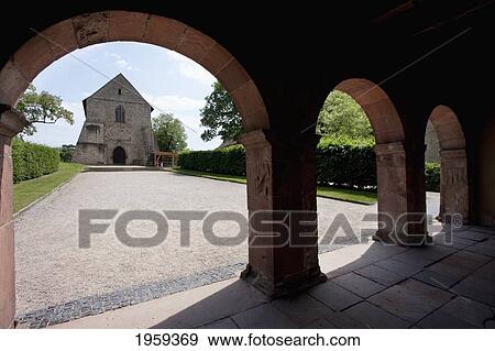 Remains Of The Abbey Church, As Seen Through The Konigshalle Or Torhalle (King's Hall Or Gatehouse) To The Abbey And Altenmunster Of Lorsch In Lorsch, Germany View Large Photo Image Stock Photo - Remains Of The Abbey Church, As Seen Through The Konigshalle Or Torhalle (King's Hall Or Gatehouse) To The Abbey And Altenmunster Of Lorsch In Lorsch, Germany. Fotosearch