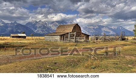 Stock Image - Remote Landscape With Mountains In Background; Mormon Row Historic District, Grand Teton National Park, Teton Range, Wyoming, Usa. Fotosearch