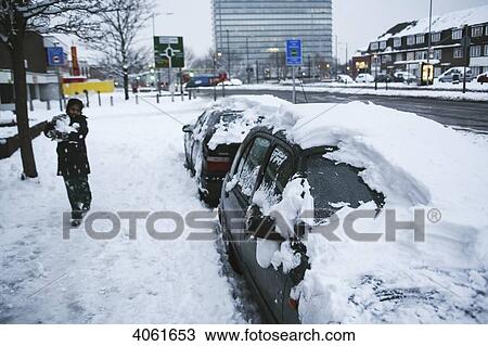 Removing some of the deep snow from snow covered cars to make a snowman, with Tolworth Tower in the background; London, England View Large Photo Image Stock Image - Removing some of the deep snow from snow covered cars to make a snowman, with Tolworth Tower in the background; London, England. Fotosearch
