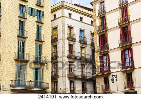 Stock Image - Residential apartment buildings with red doors and green doors; Barcelona, Spain. Fotosearch
