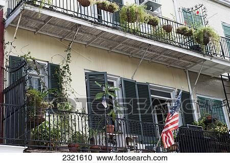 Residential building with balconies and American flag; Louisiana, New Orleans, USA View Large Photo Image Stock Image - Residential building with balconies and American flag; Louisiana, New Orleans, USA. Fotosearch