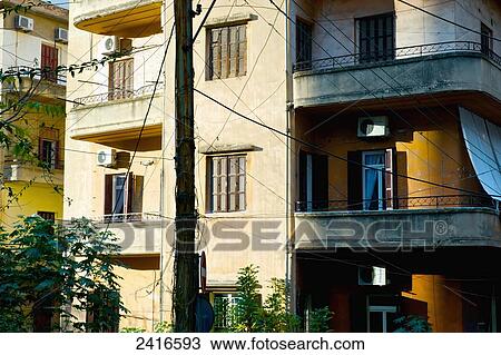 Stock Image - Residential building with electrical wires strung from a pole; Beirut, Lebanon. Fotosearch