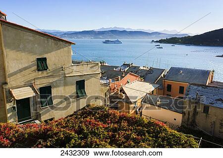 Residential buildings along the coast of the Italian Riviera with boats in the water; Porto Venere, Liguria, Italy View Large Photo Image Stock Photo - Residential buildings along the coast of the Italian Riviera with boats in the water; Porto Venere, Liguria, Italy. Fotosearch