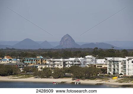 Stock Photo - Residential buildings along the water with Glass House Mountains in the distance; Caloundra, Queensland, Australia. Fotosearch