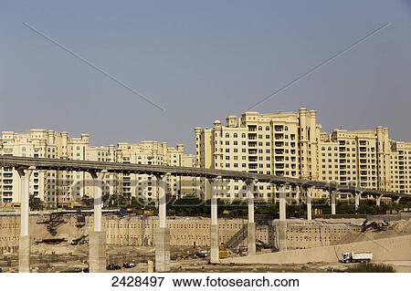 Residential buildings and a construction site under a roadway; Dubai, United Arab Emirates View Large Photo Image Stock Photo - Residential buildings and a construction site under a roadway; Dubai, United Arab Emirates. Fotosearch