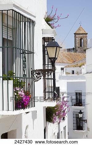 Stock Image - Residential buildings decorated with flowers; Vejer de la Frontera, Andalusia, Spain. Fotosearch