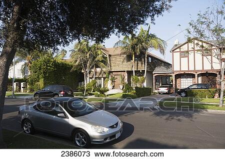 Residential street with homes and parked cars; California, United States of America View Large Photo Image Stock Image - Residential street with homes and parked cars; California, United States of America. Fotosearch