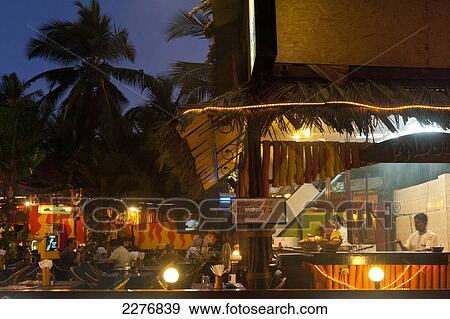 Stock Photo - Restaurant at dusk; Candolim, Goa, India. Fotosearch