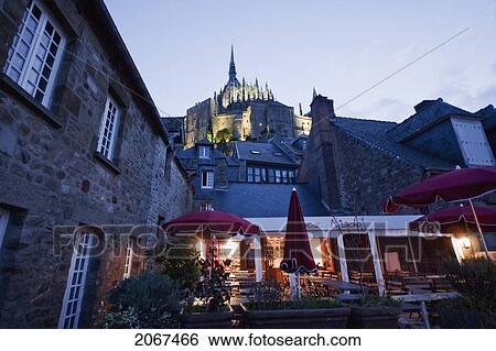 Restaurant In The Fortified Village And Abbey Of Mont-Saint-Michel In The Evening, France View Large Photo Image Stock Photograph - Restaurant In The Fortified Village And Abbey Of Mont-Saint-Michel In The Evening, France. Fotosearch