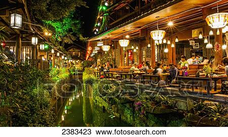 Stock Image - Restaurant lights illuminated at night; Lijiang, Yunnan, China. Fotosearch