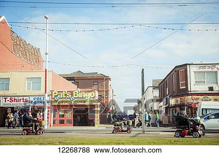 Retail shops and pedestrians on the street; Blackpool, Lancashire, England View Large Photo Image Stock Photo - Retail shops and pedestrians on the street; Blackpool, Lancashire, England. Fotosearch