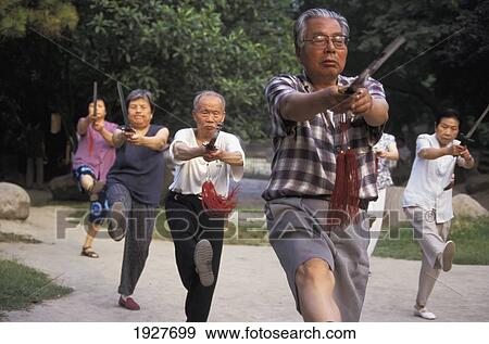 Stock Photo - Retirees Doing Tai Chi At 6Am By City Walls. Fotosearch
