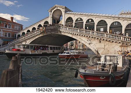 Stock Image - Rialto Bridge And Vaporetto; Venice Italy. Fotosearch