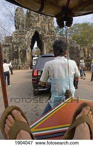 Rickshaw And Car By Bayon Temple, Angkor, Siem Reap, Cambodia View Large Photo Image Stock Photo - Rickshaw And Car By Bayon Temple, Angkor, Siem Reap, Cambodia. Fotosearch
