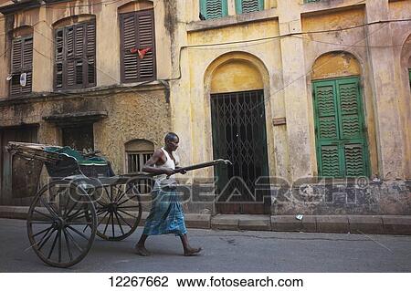 Stock Image - Rickshaw puller; Kolkata, West Bengal, India. Fotosearch