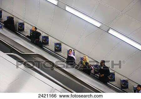 Stock Photograph - Riding an escalator; London, England. Fotosearch