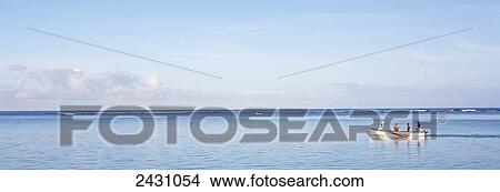 Picture - Riding in a boat off the shore of an island in the Indian Ocean; Mauritius. Fotosearch