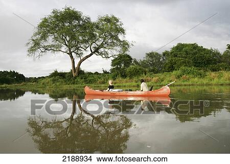 Riding in a canoe in a tranquil river, Lower Zambezi National Park; Zambia View Large Photo Image Picture - Riding in a canoe in a tranquil river, Lower Zambezi National Park; Zambia. Fotosearch