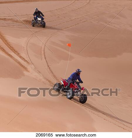 Stock Photography - Riding Quads On Sand Dunes; Utah United States Of America. Fotosearch