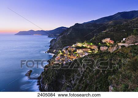 Picture - Riomaggiore and the coastline at dusk, Cinque Terre; Liguria, Italy. Fotosearch