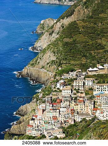 Stock Photo - Riomaggiore and the coastline, Cinque Terre; Liguria, Italy. Fotosearch