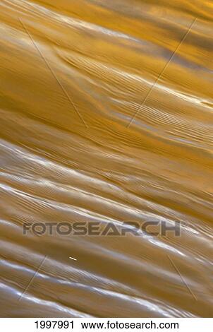 Ripple, Crinkled Surface Texture Of Golden Brown Water. View Large Photo Image Stock Image - Ripple, Crinkled Surface Texture Of Golden Brown Water.. Fotosearch