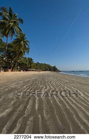 Picture - Ripples in the sand on a beach; Goa, India. Fotosearch
