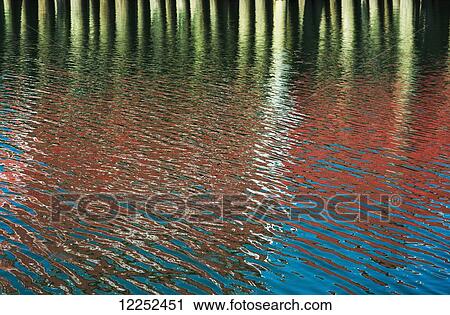 Stock Image - Ripples make patterns of reflections; Ilwaco, Washington, United States of America. Fotosearch
