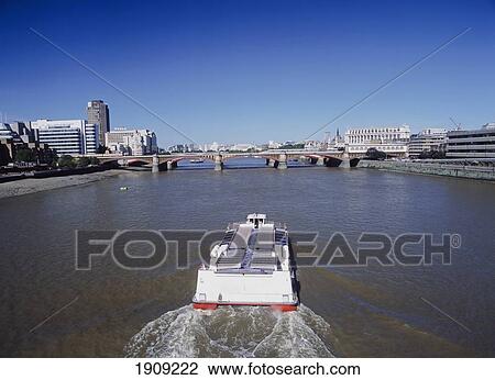 Stock Image - River Cruise Boat Heading Towards Cannon Street Rail Bridge. London, Uk.. Fotosearch