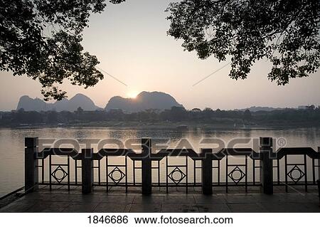 Stock Photograph - River Waterfront In Evening Light. Fotosearch