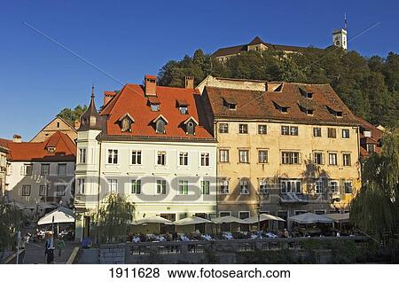 Riverfront Buildings With Castle Hill In Background, Ljubljana, Slovenia View Large Photo Image Stock Photo - Riverfront Buildings With Castle Hill In Background, Ljubljana, Slovenia. Fotosearch