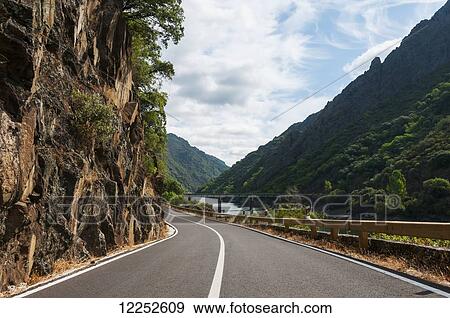 Stock Photo - Road along Sil river, location of the famous Ribeira Sacra vineyard; Galicia, Spain. Fotosearch