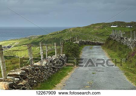 Stock Photo - Road and stone walls on Inishturk island, Wild Atlantic Way; County Mayo, Ireland. Fotosearch