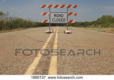 Stock Photo - Road Closed Sign On Highway, Low Angle View. Fotosearch