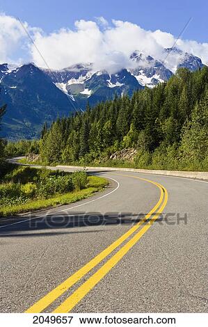 Stock Photo - Road Curving Through Mountain Landscape, Highway 37A, Northern British Columbia. Fotosearch