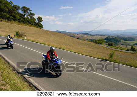 Stock Image - Road Landscape Motorcyclist, Tuscany, Italy. Fotosearch