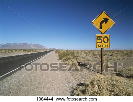 Road Sign Beside Road Running Through The Mojave Desert View Large Photo Image Picture - Road Sign Beside Road Running Through The Mojave Desert. Fotosearch