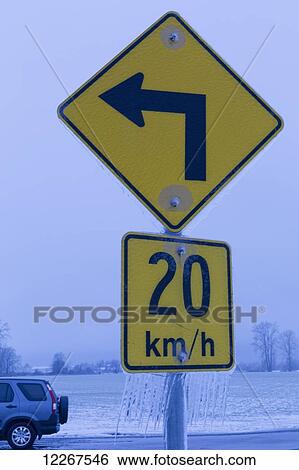 Road sign indicating speed at left turn with icicles hanging from it; British Columbia, Canada View Large Photo Image Stock Photograph - Road sign indicating speed at left turn with icicles hanging from it; British Columbia, Canada. Fotosearch