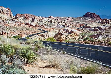 Stock Image - Road through colourful desert landscape, Valley of Fire State Park; Nevada, United States of America. Fotosearch
