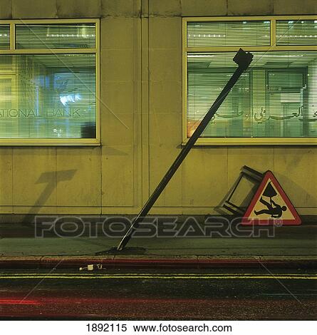 Stock Photography - Road Works Sign On Pavement Against Building. Fotosearch