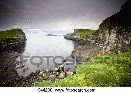Stock Image - Rock Ledges Along The Coastline; Papey Island Iceland. Fotosearch