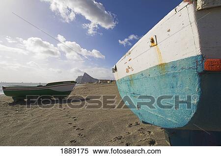 Stock Photography - Rock Of Gibraltar And Fishing Boat On Beach. Fotosearch