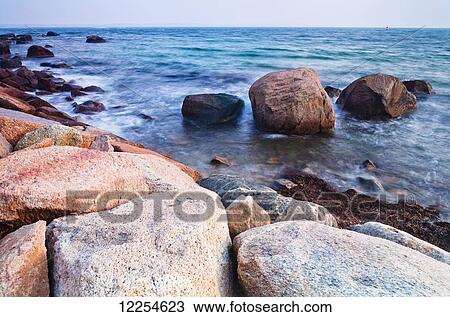 Stock Image - Rocks along the coastline; Falmouth, Massachusetts, United States of America. Fotosearch