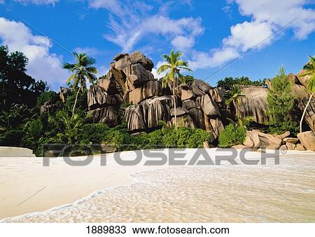 Stock Image - Rocky Cliff On Beach. Fotosearch