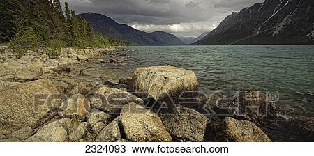 Stock Image - Rocky shore of Kusawa Lake; Yukon, Canada. Fotosearch