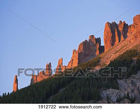 Stock Image - Rocky Spires On A Ridge In The San Juan Mountains Catching The Last Rays Of The Setting Sun; Colorado, United States Of America. Fotosearch