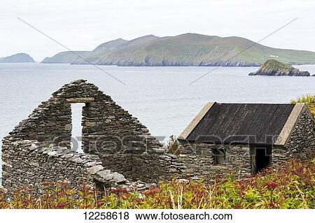 Roofless stone building and roofed stone building overlooking the bay with islands in the background; Dingle, County Kerry, Ireland View Large Photo Image Stock Photo - Roofless stone building and roofed stone building overlooking the bay with islands in the background; Dingle, County Kerry, Ireland. Fotosearch